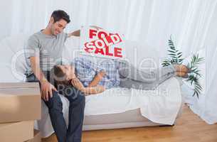 Woman lying on her husband in the couch in their new house