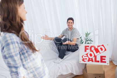 Man in his new house chatting with his wife