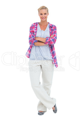Happy woman standing with arms crossed looking at camera