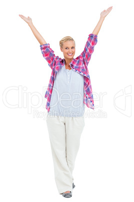 Blonde woman standing with hands up in air