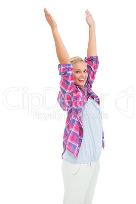 Happy woman standing with hands up in air