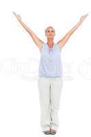 Blonde woman standing with arms outstretched