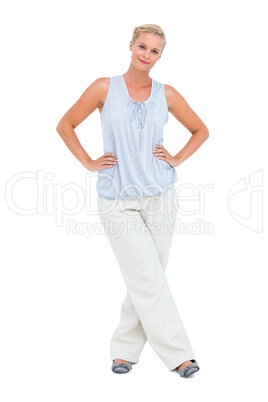 Woman smiling at camera with hands on hips