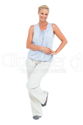 Woman smiling with hand on hip looking at camera