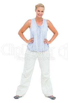 Woman smiling with hands on hips looking at camera