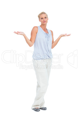 Blonde woman with arms raised in question looking at camera