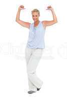 Blonde woman standing with thumbs up pointing to herself