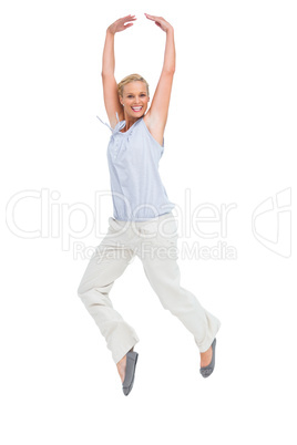 Blonde woman jumping like a ballerina