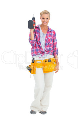 Woman standing holding a drill