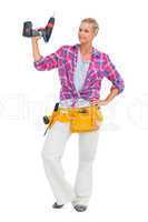 Handy woman standing with a power drill