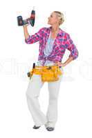 Handy woman standing with power drill