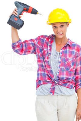 Attractive handy woman holding a power drill