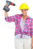 Attractive handy woman holding a power drill