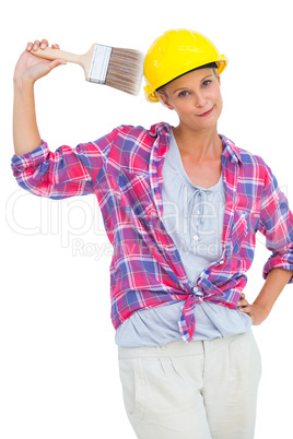 Beautiful handy woman holding a brush and smiling at camera