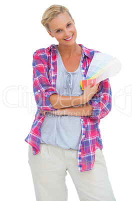 Attractive young woman smiling at camera holding colour charts