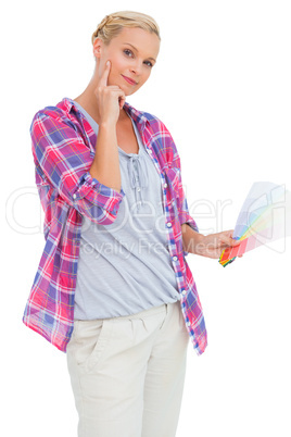 Blonde holding color charts and picking colour
