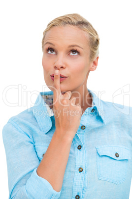 Blonde woman standing with her finger on her lips