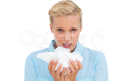 Blonde sick woman holding lots of tissues