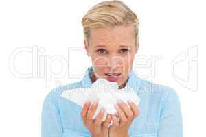 Blonde sick woman holding lots of tissues