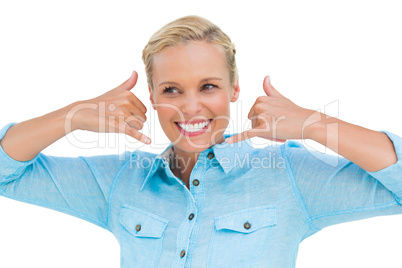 Happy beautiful blonde doing symbols of phone with her hands