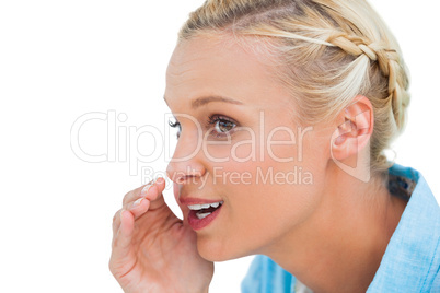 Close up of a blonde speaking to someone and looking at somethin