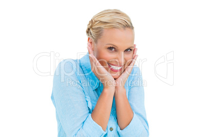 Pretty woman laughing at camera with hands on face