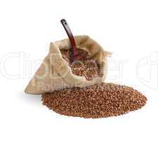 buckwheat in bag with spoon on white background