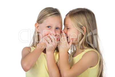 Little girl whispering to her sister