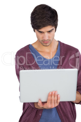 Serious man using laptop