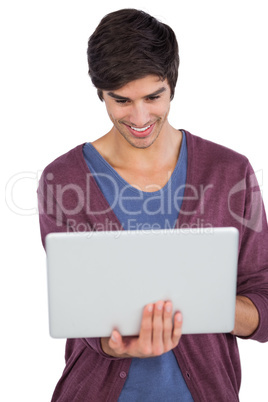 Smiling man using a laptop