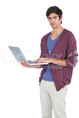 Serious man holding a laptop