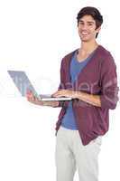 Cheerful young man holding a laptop