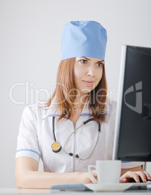 doctor looks at a computer monitor