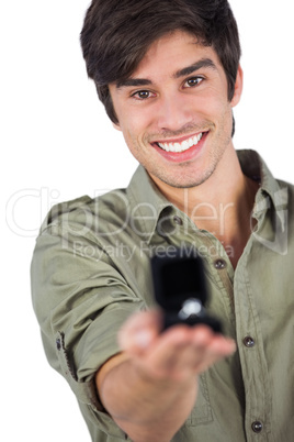 Smiling man holding engagement ring