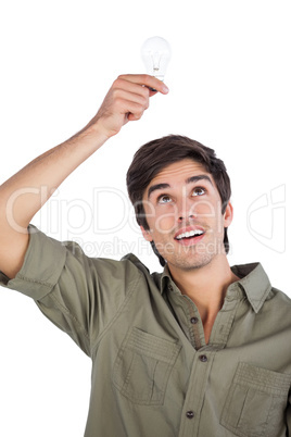 Man holding light bulb above his head