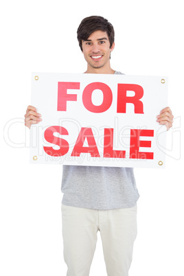 Man holding a for sale panel