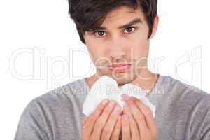 Young man using handkerchief