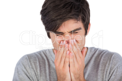 Young man sneezing