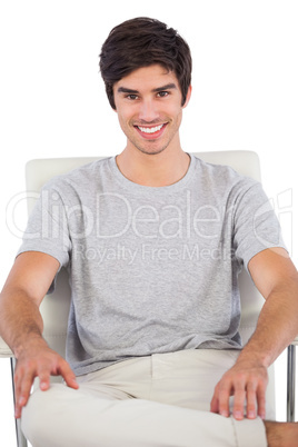 Smiing man sitting on a office chair