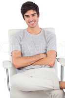 Smiling man with arms crossed sitting on a swivel chair