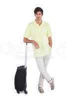 Calm man standing with his suitcase