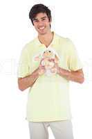 Smiling man holding a sheep plush