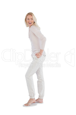 Happy woman with hands in pockets