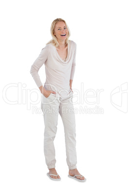 Laughing woman with hands in pockets