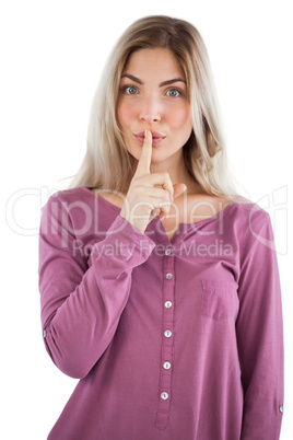 Young woman with finger on her lips