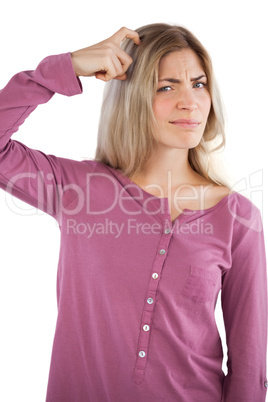 Young woman scratching head