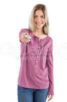 Smiling woman holding remote control