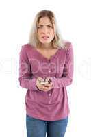 Doubtful woman with remote control