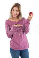 Blonde woman presenting an apple