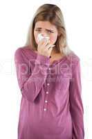 Woman blowing her nose while looking at the camera